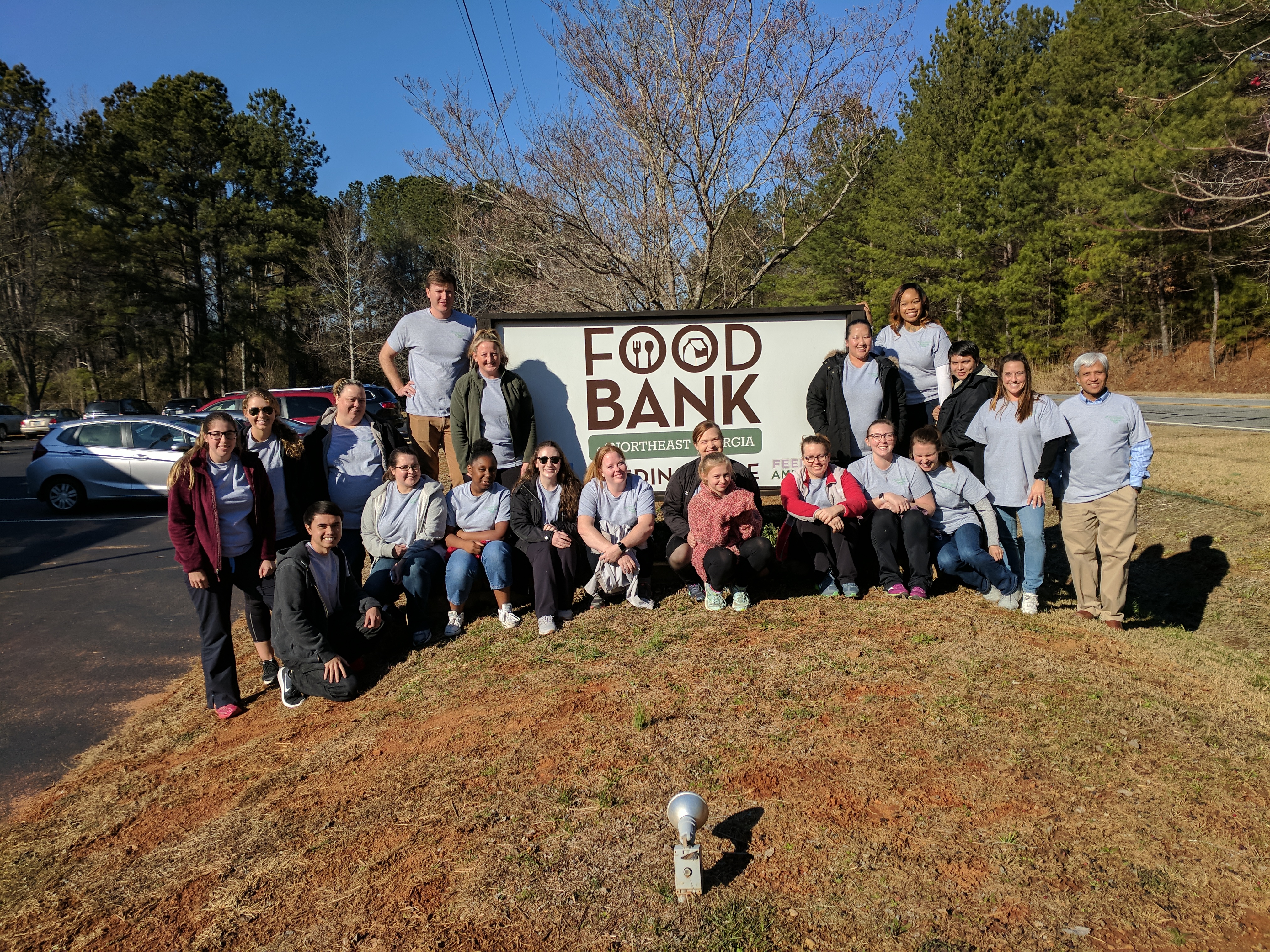 ARC team members in front of Food Bank sign